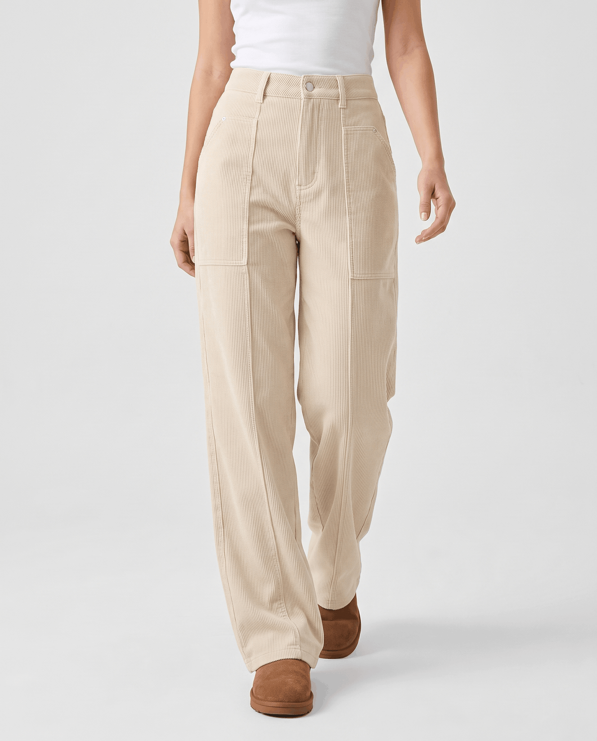 Front view of cream ribbed wide-leg trousers with front patch pockets and brown loafers
