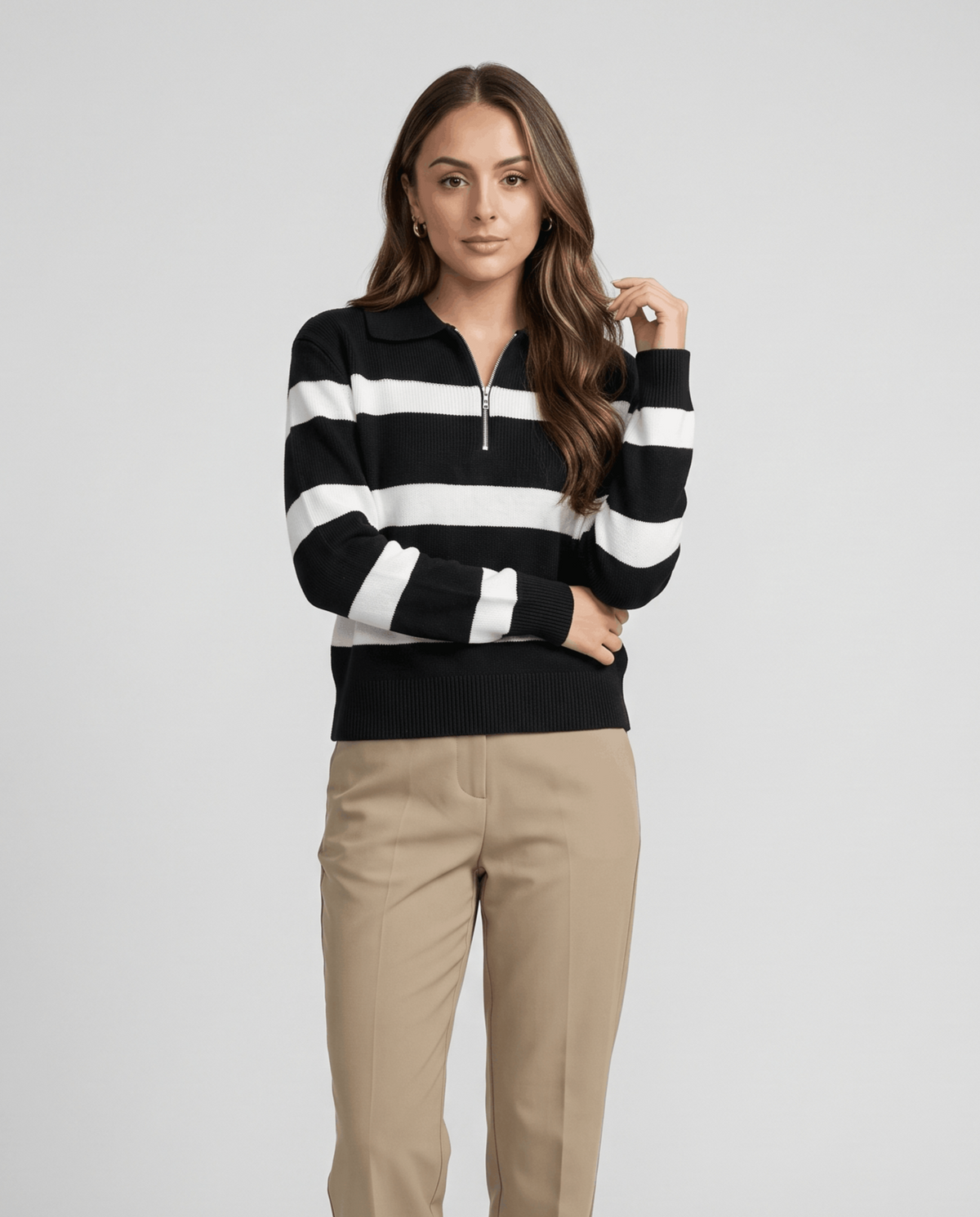 Front view of black and white striped pullover styled with khaki trousers