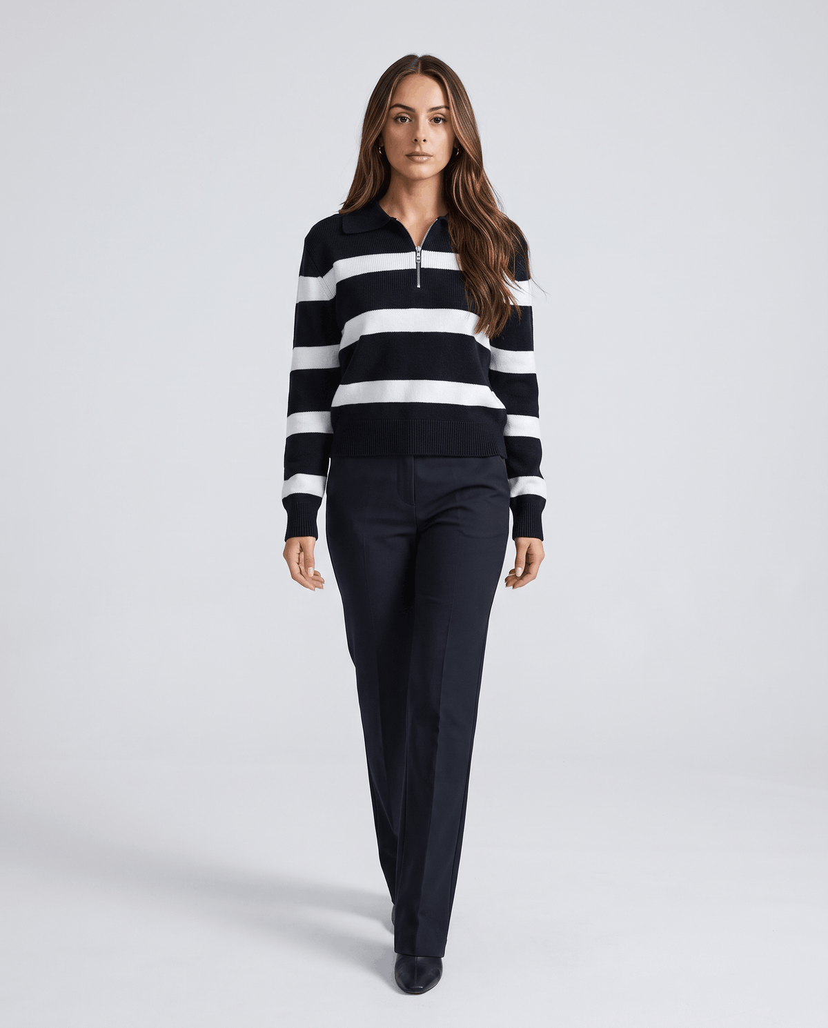 Full-length view of black striped pullover with black wide-leg trousers