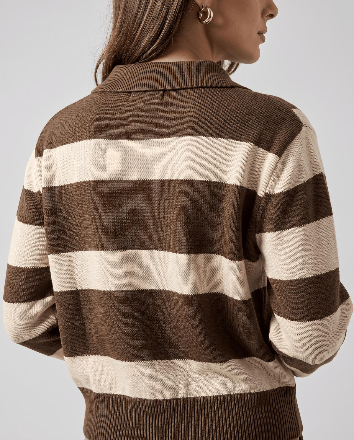 Back view of brown and cream striped sweater with ribbed hem and cuffs