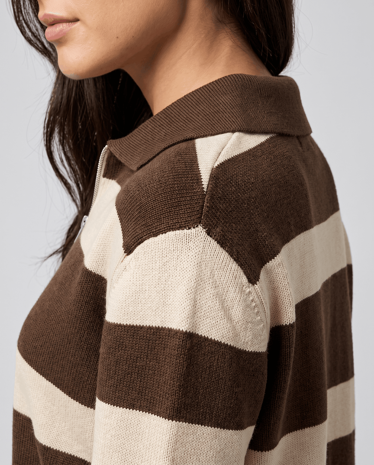 Shoulder detail showing brown and cream stripes and polo collar on a knit