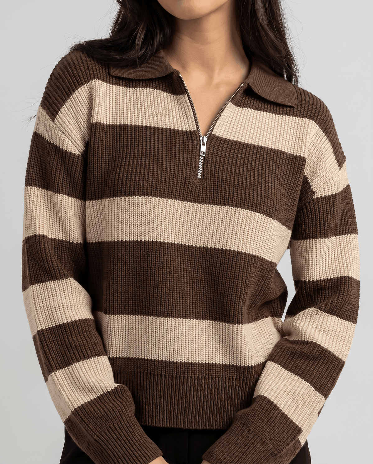 Cropped front view of brown striped knit pullover with half-open silver zip