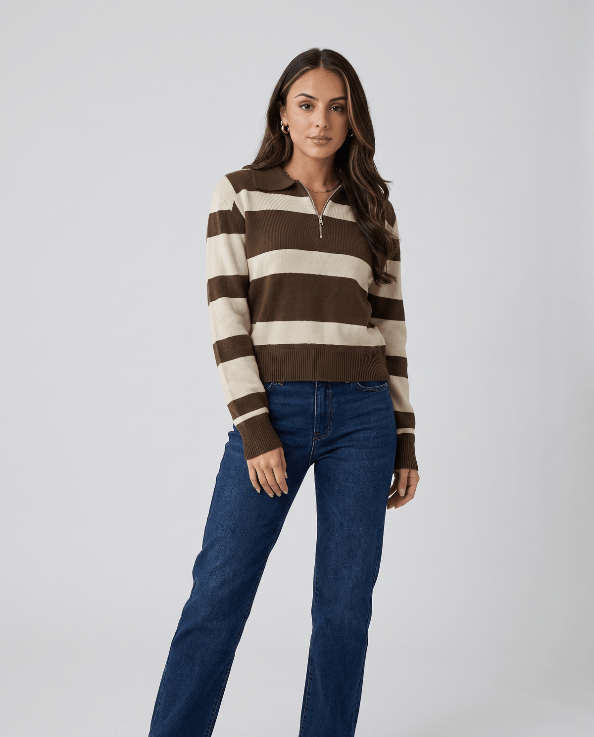 Full-length view of brown striped pullover with dark jeans and ankle boots