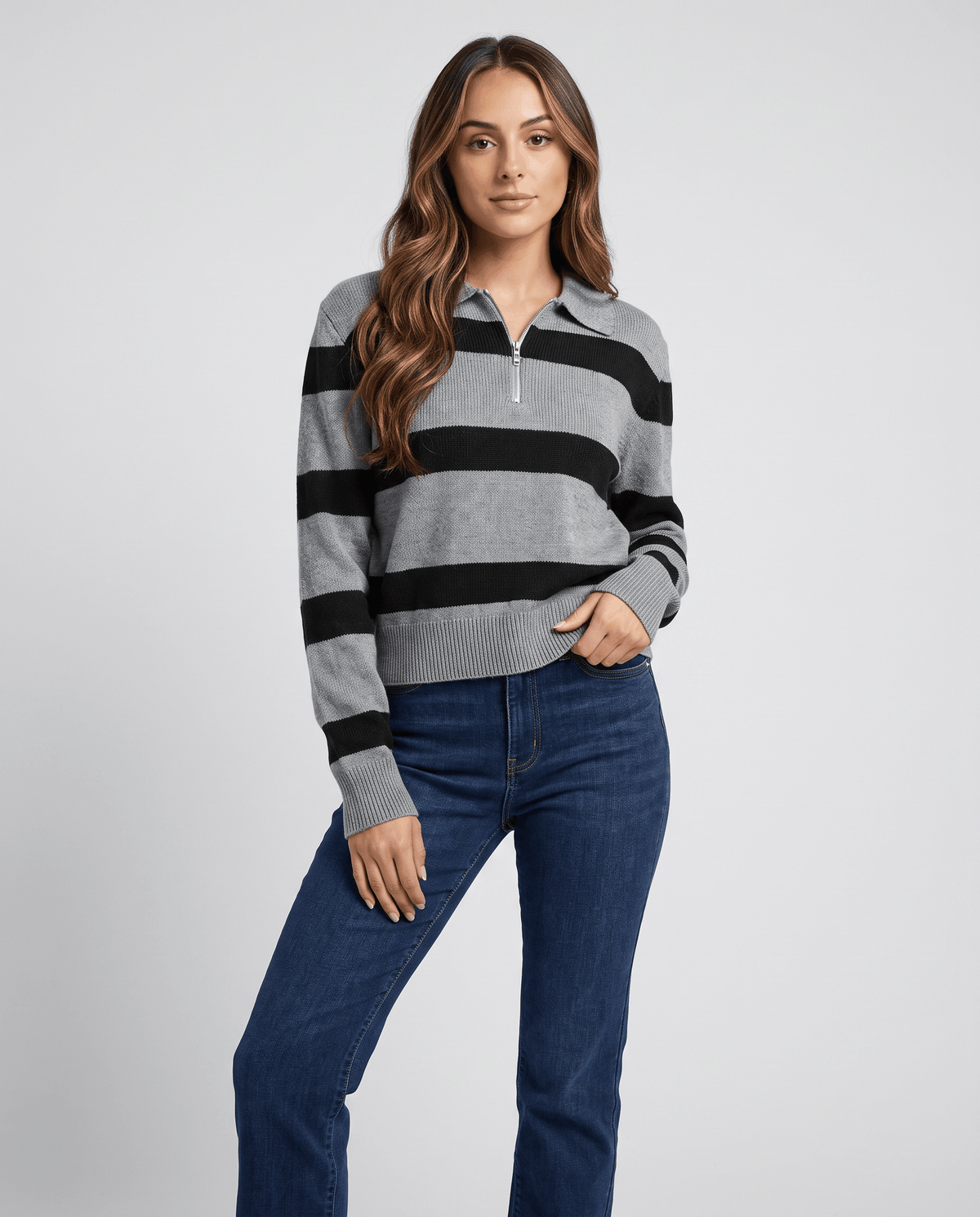 Front view of gray and black striped pullover worn with dark wash jeans