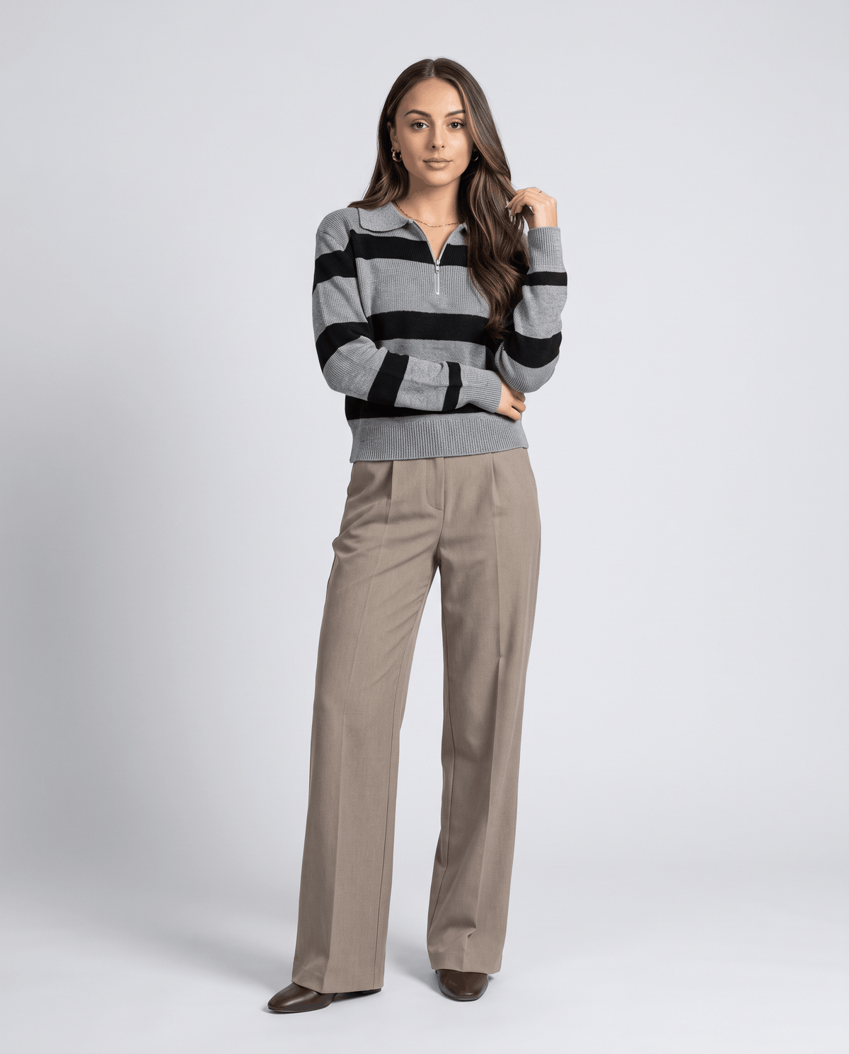 Full-length view of gray striped pullover with khaki wide-leg trousers