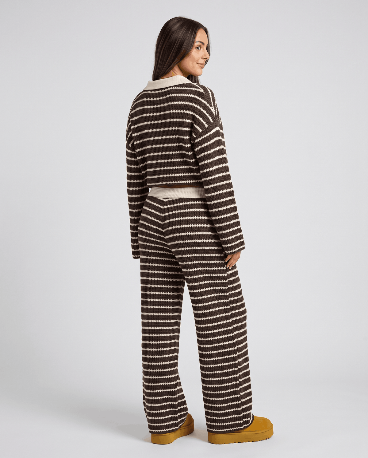 Back view of woman in brown striped knit top and matching wide-leg pants