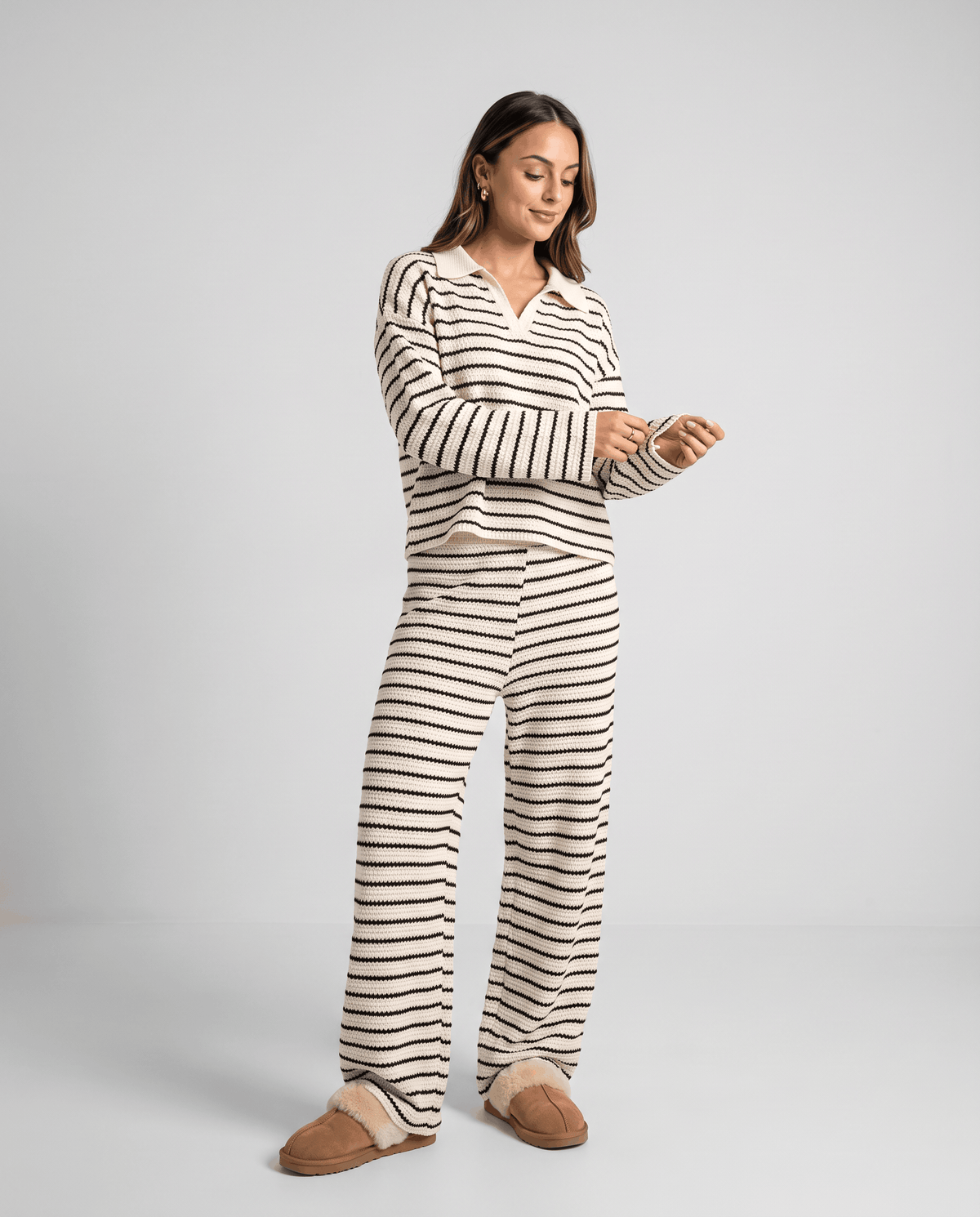 Woman wearing a cream striped knit top and matching wide-leg pants