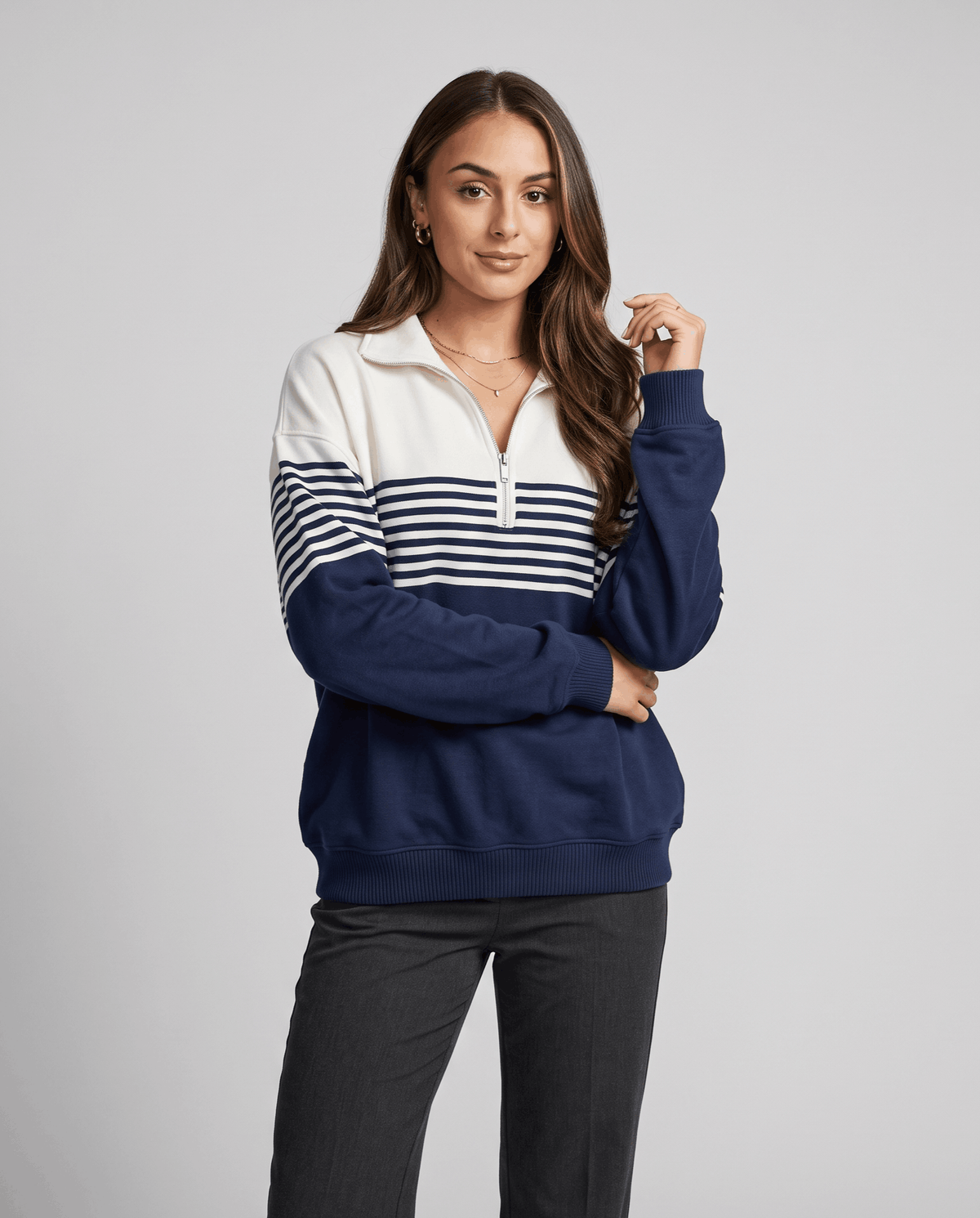 Navy and ivory striped pullover styled with black pants, front view