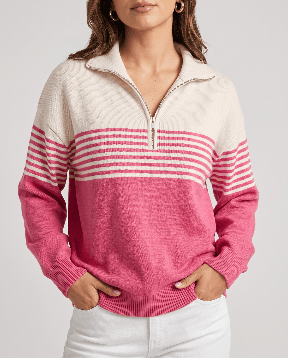 Cropped front view of fuchsia color-block pullover with open collar and white pants