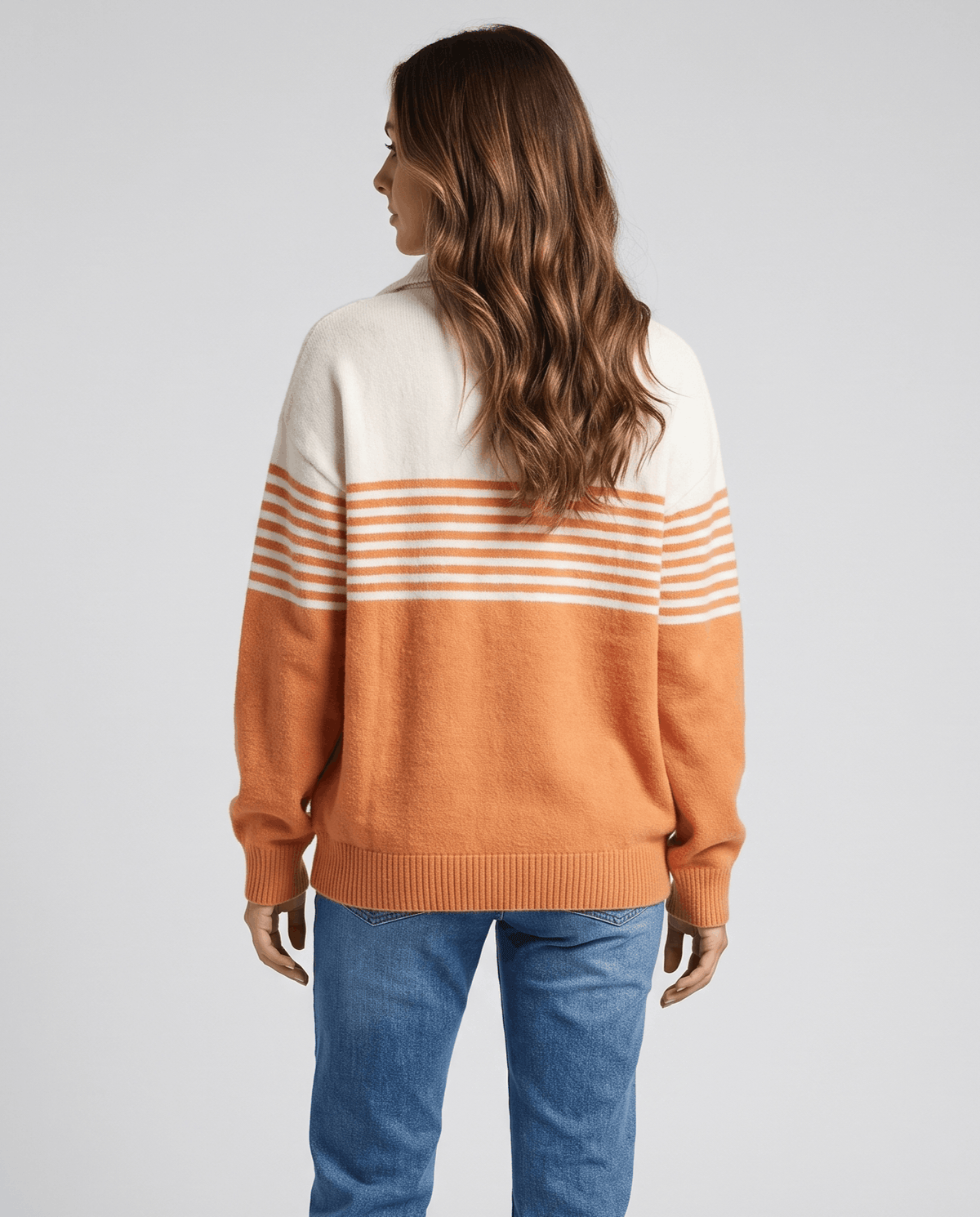 Back view of orange and ivory pullover with stripes and relaxed drop shoulders