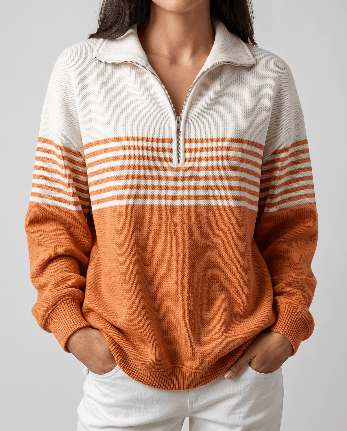 Cropped front view of burnt orange color-block pullover with half-open zip collar