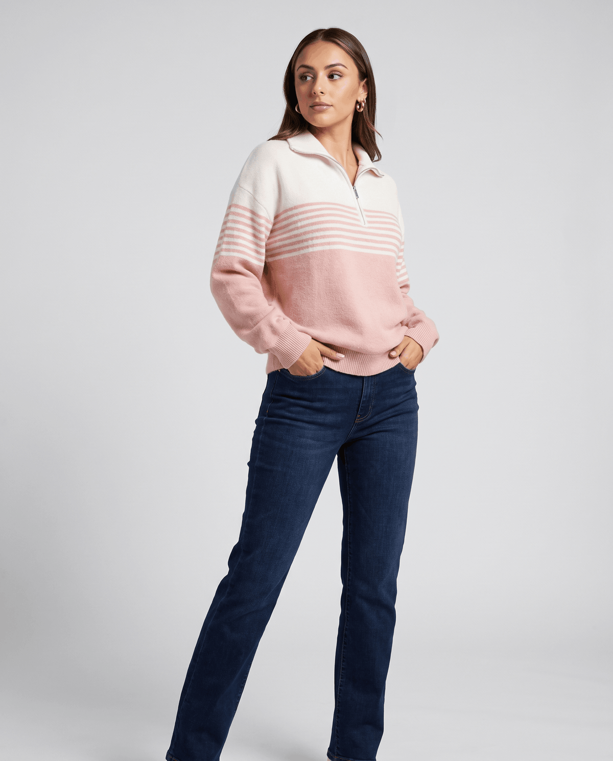 Model in light pink striped pullover and dark skinny jeans, full-length front view