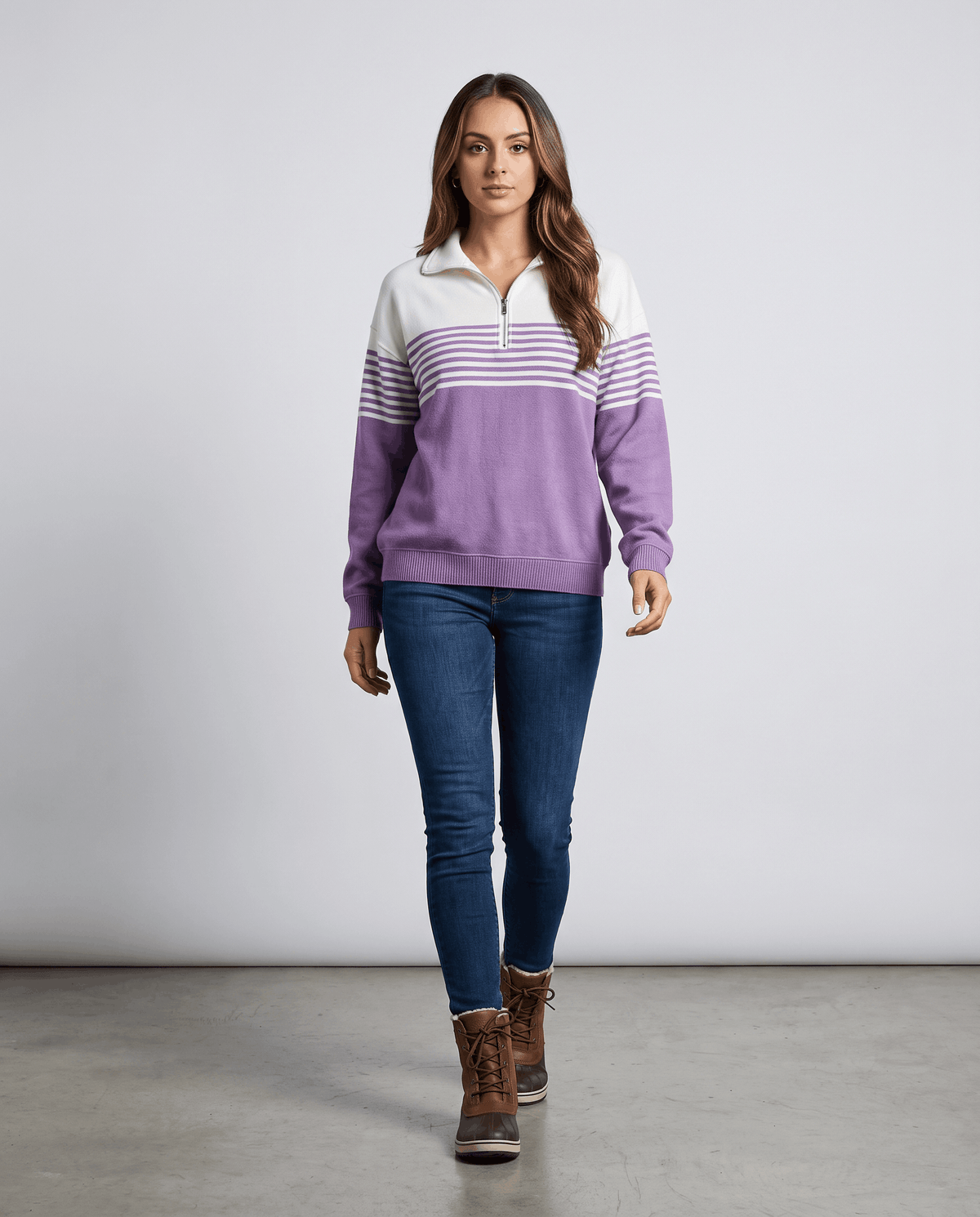 Full-length view of model in purple two-tone pullover, jeans and brown ankle boots