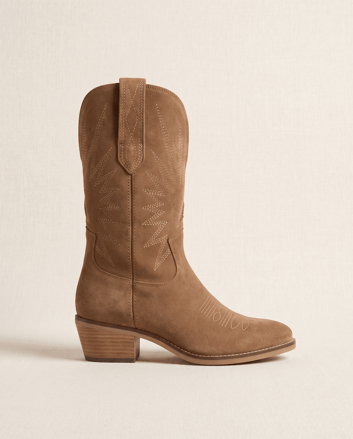 Side view of a single mid-calf suede boot showing pull tab, stitched toe and stacked heel