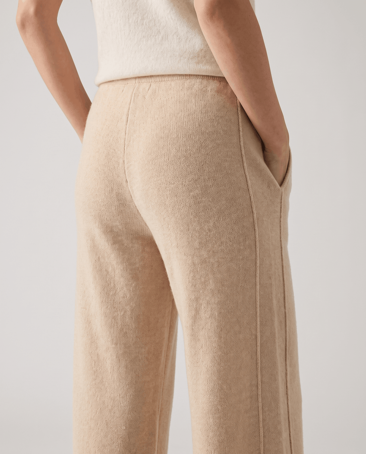 Close-up of beige knit texture at the back with side pocket detail