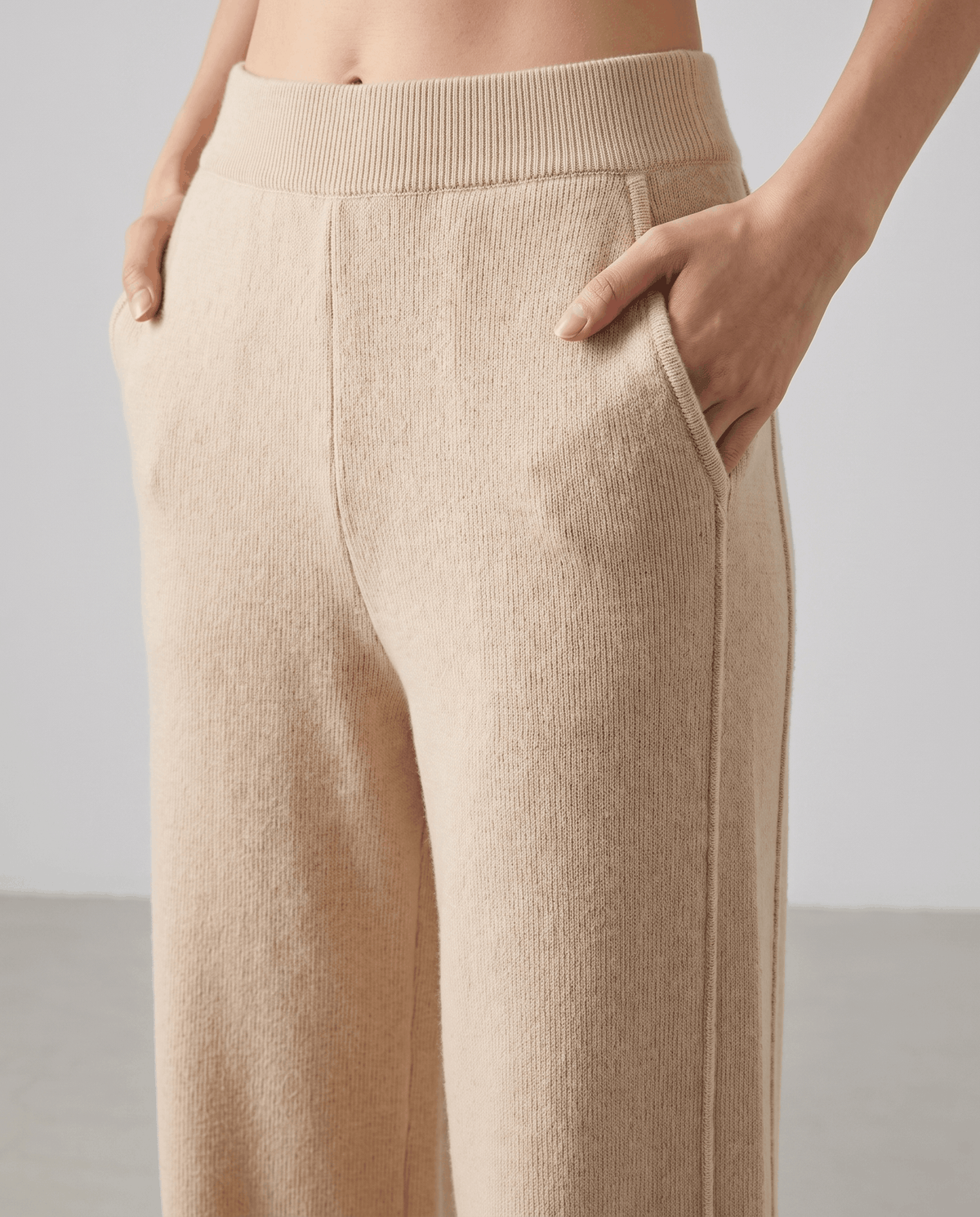 Front close-up of beige ribbed pull-on waistband and side pockets