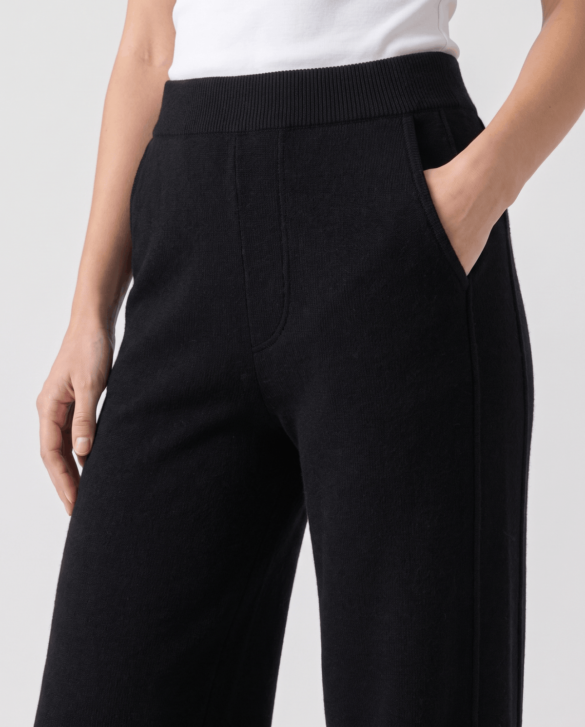 Front close-up of black ribbed waistband and side pocket opening