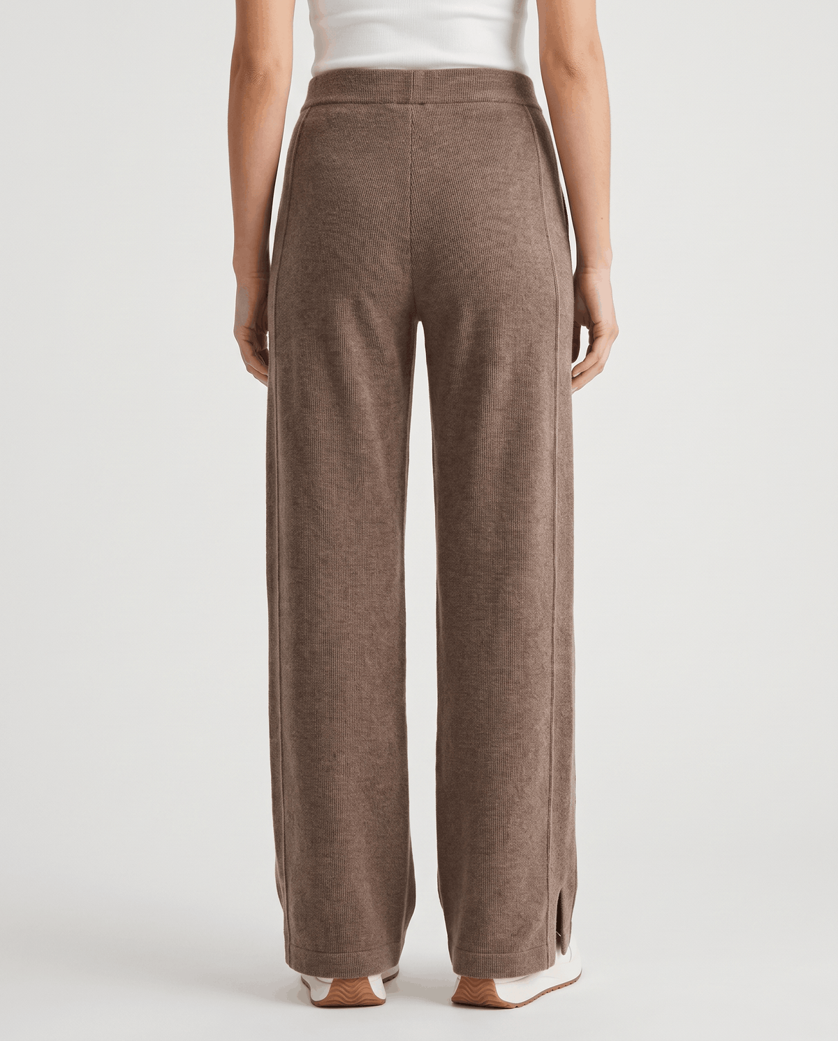 Full back view of khaki straight-leg knit pants with side hem slits