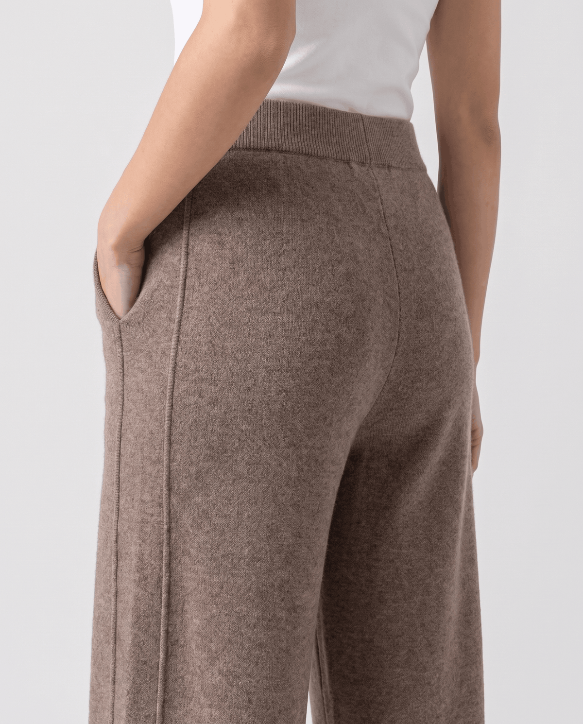 Back detail of khaki pants showing ribbed waist, pocket and center leg seam