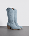 Pair of women's tall cowboy boots in light blue with stitched shaft and block heel