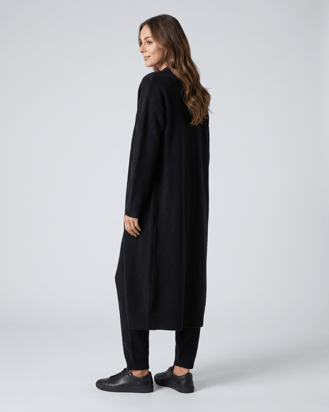 Back view of the black long cardigan coat, full-length