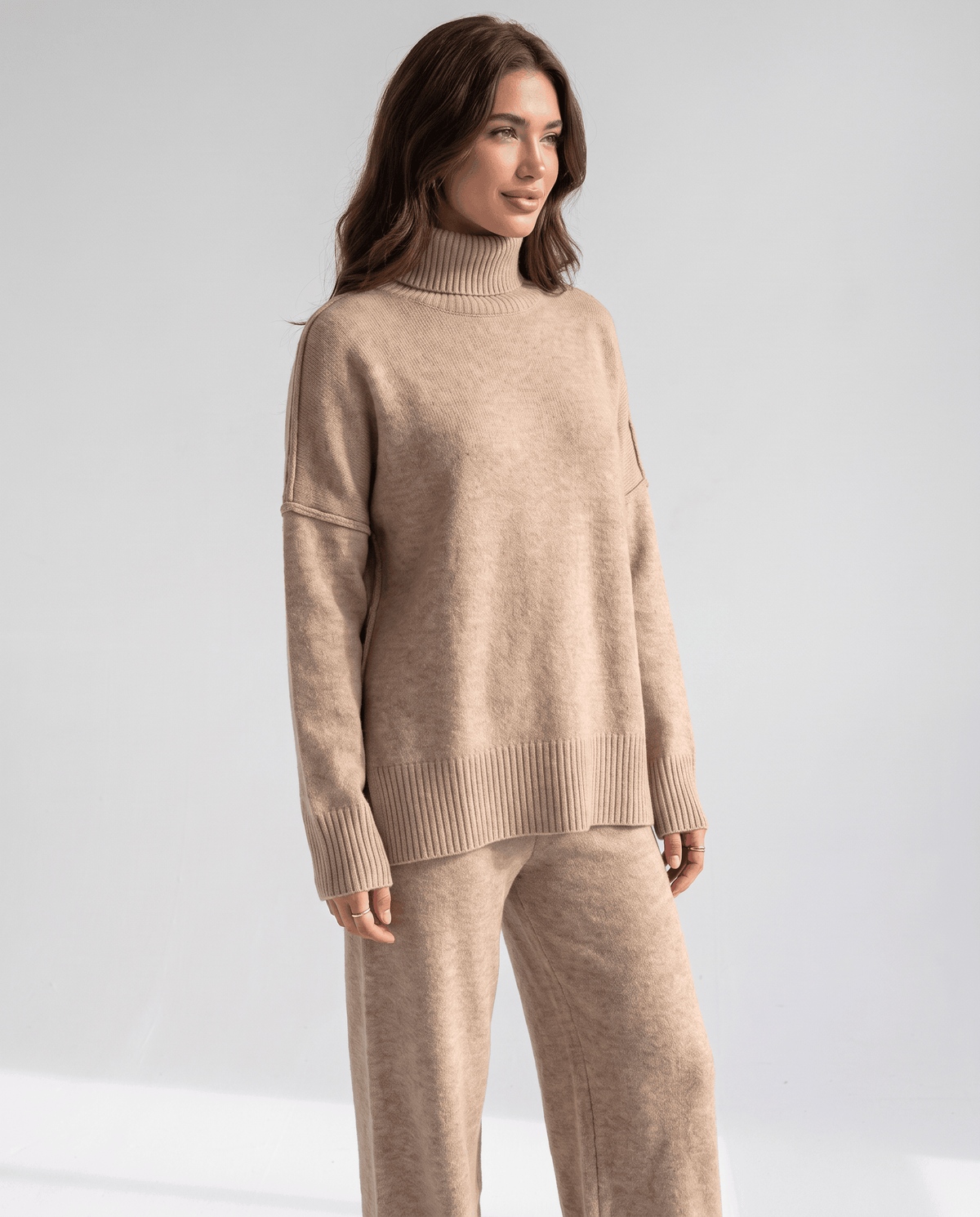 Beige oversized knit turtleneck sweater with drop shoulders, front view