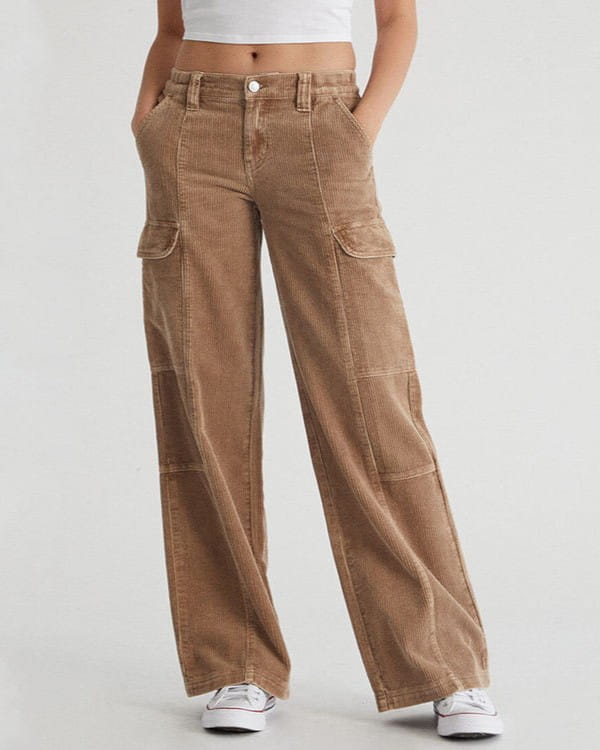 Straight-on front view of tan wide-leg cargo pants with hands in the front pockets