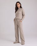 Woman in beige wide-leg lounge set with ribbed knit top and drawstring pants, front view