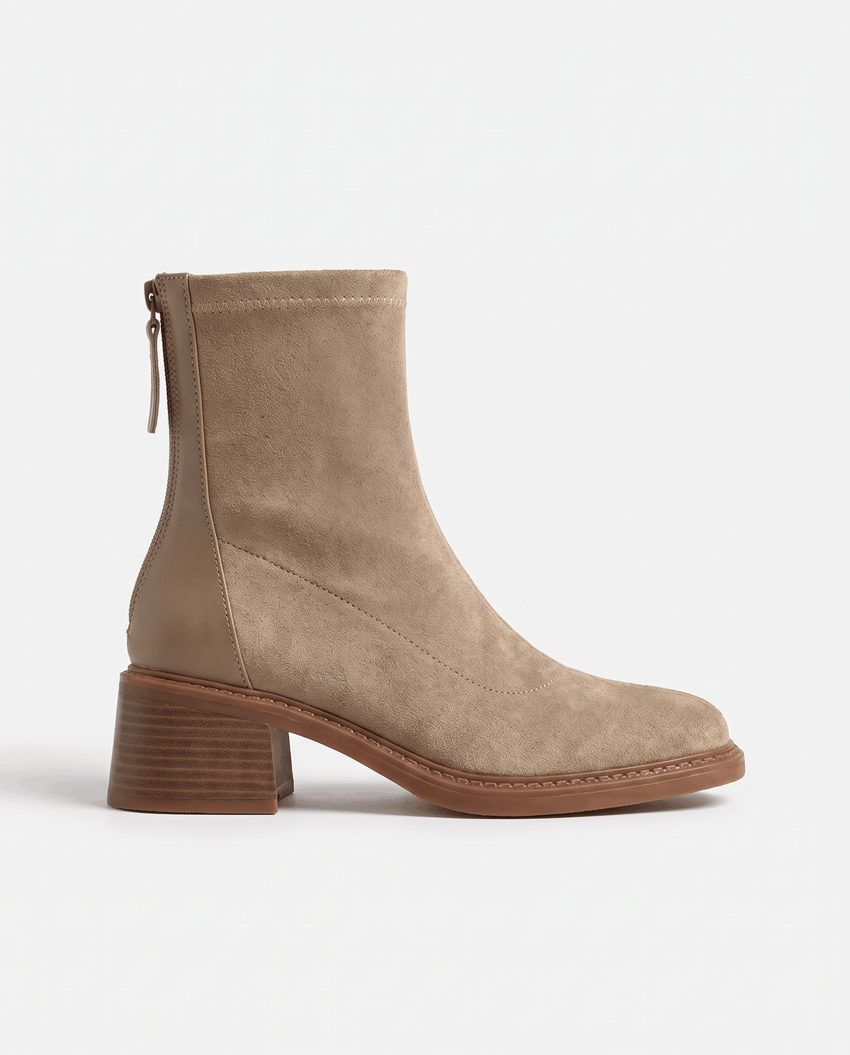 Side view of a beige suede ankle boot with back zip and block heel