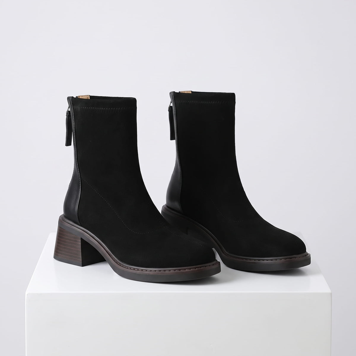 Pair of black suede block heel ankle boots with stretch shaft