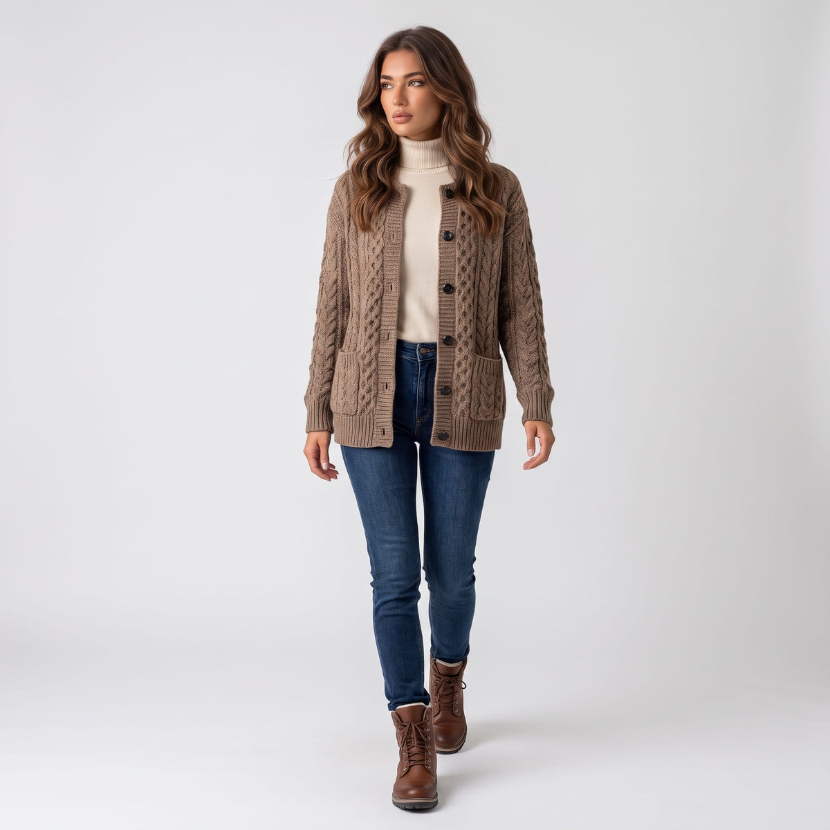 Full-length look with camel cable-knit cardigan, blue jeans and brown boots