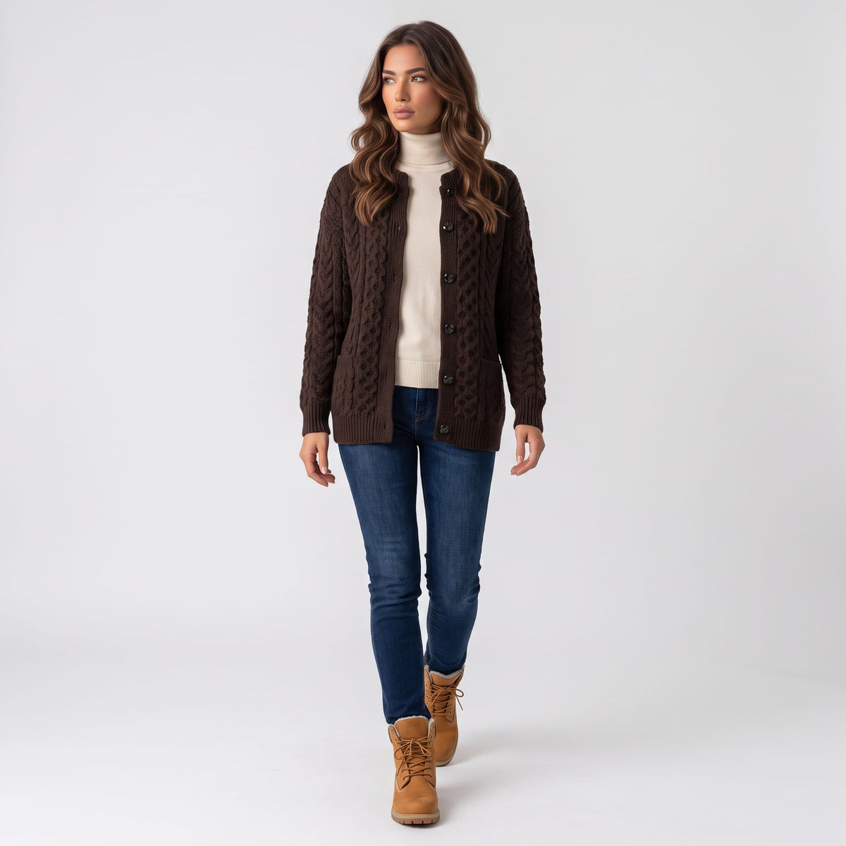 Full-length look with dark brown cable-knit cardigan, blue jeans and tan boots