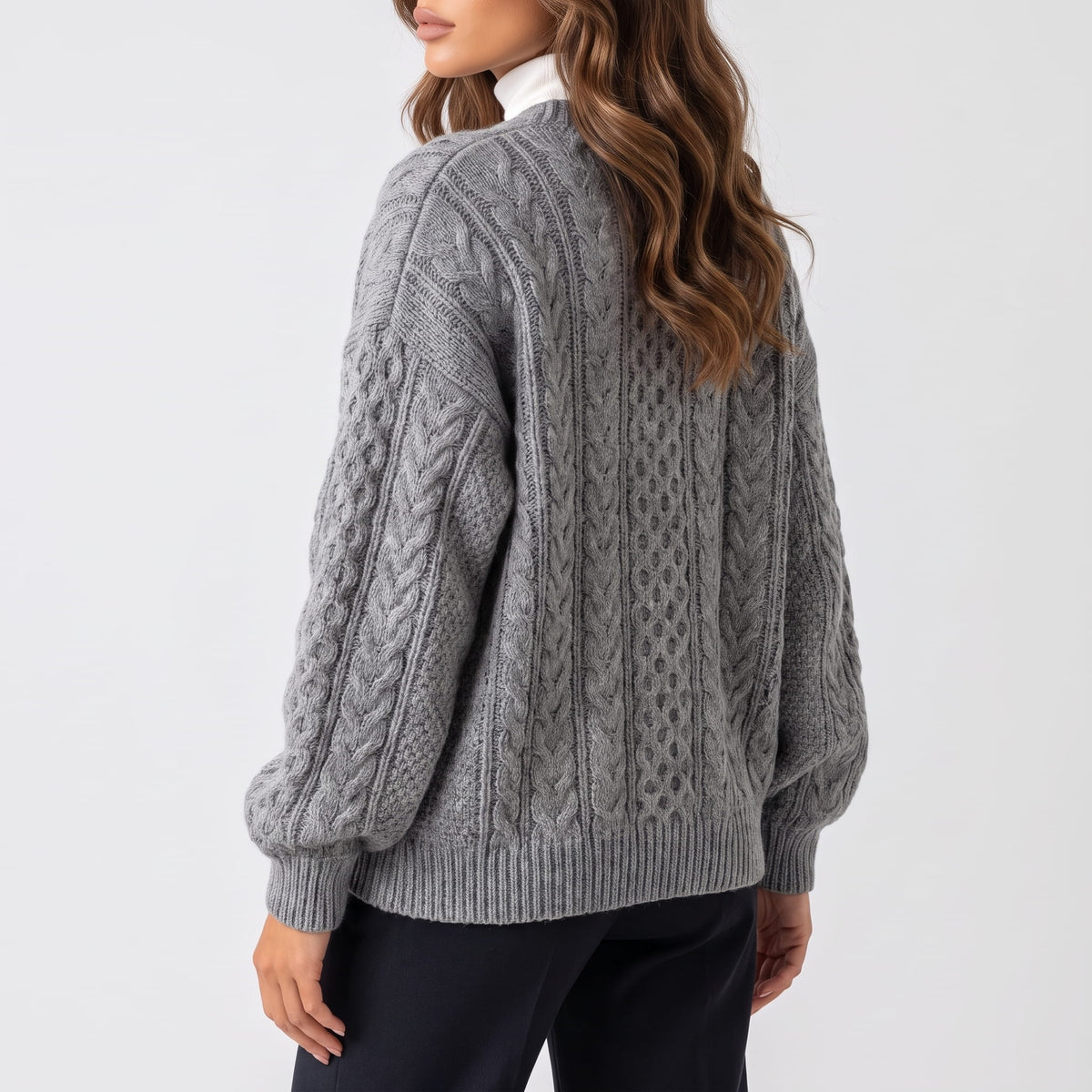 Back view of gray cable-knit cardigan with relaxed sleeves