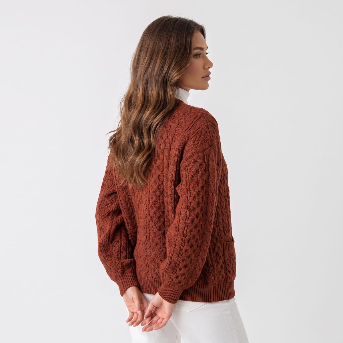 Back view of maroon cable-knit cardigan with relaxed sleeves