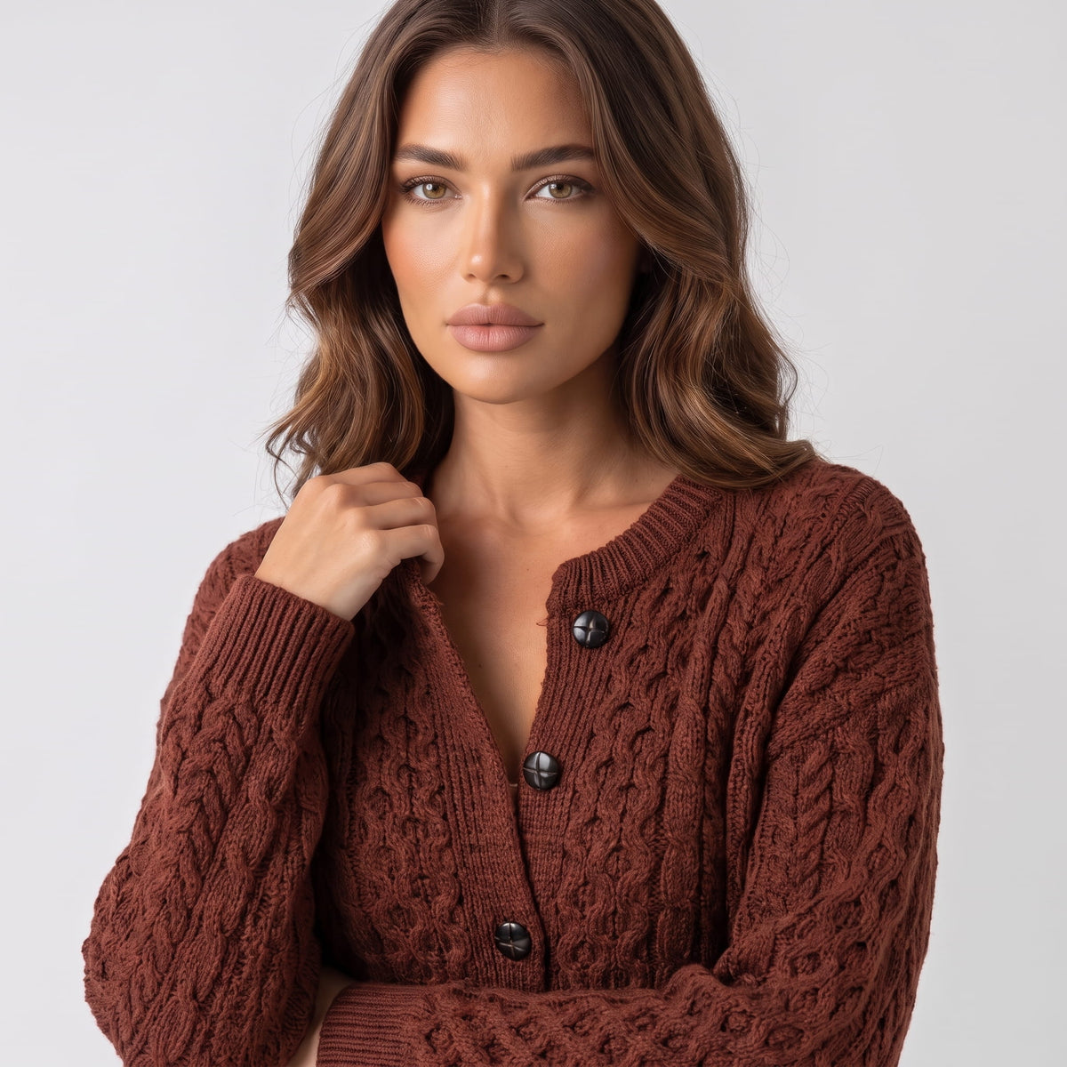 Maroon cable-knit cardigan buttons and cable pattern shown in close view