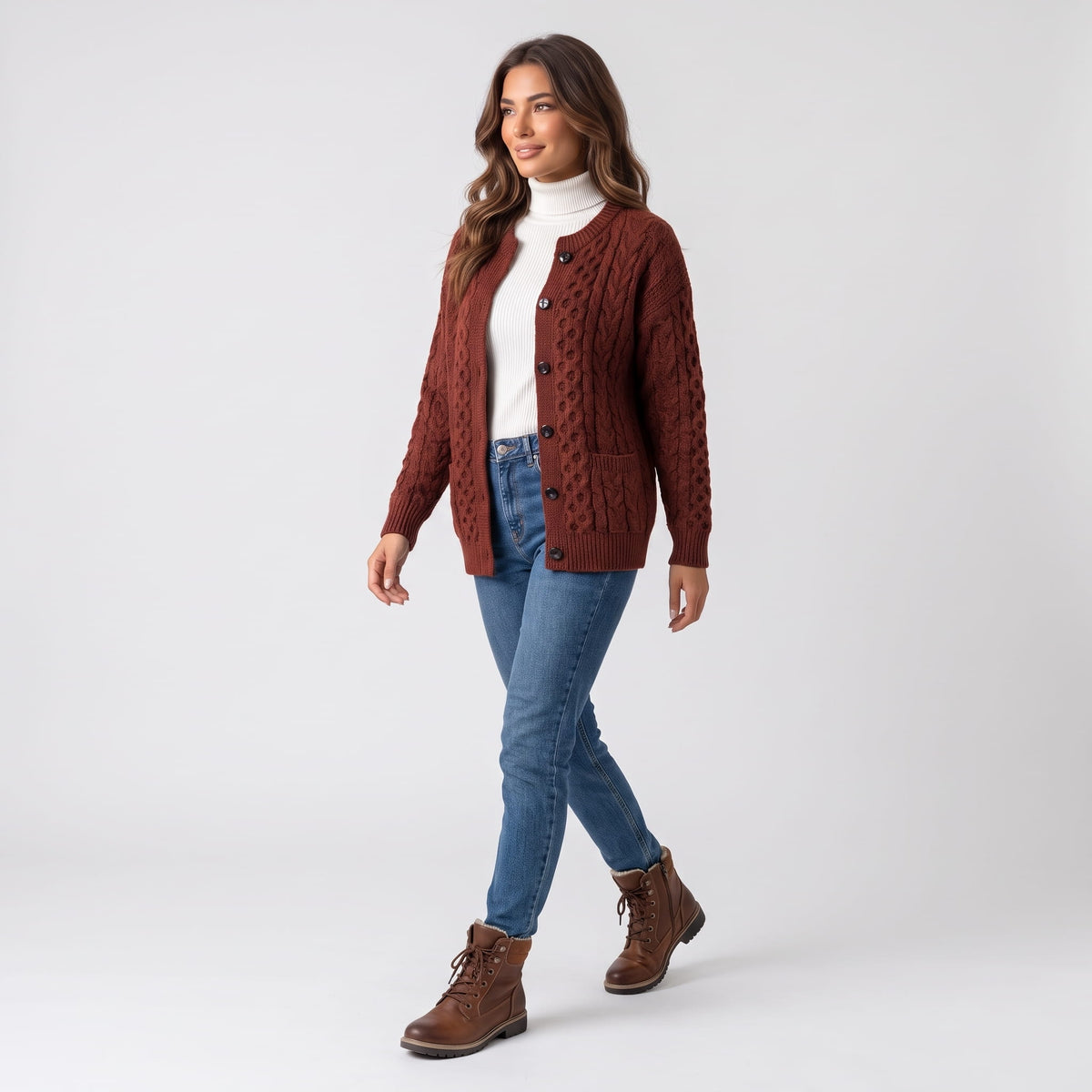 Full-length look with maroon cable-knit cardigan, blue jeans and brown boots