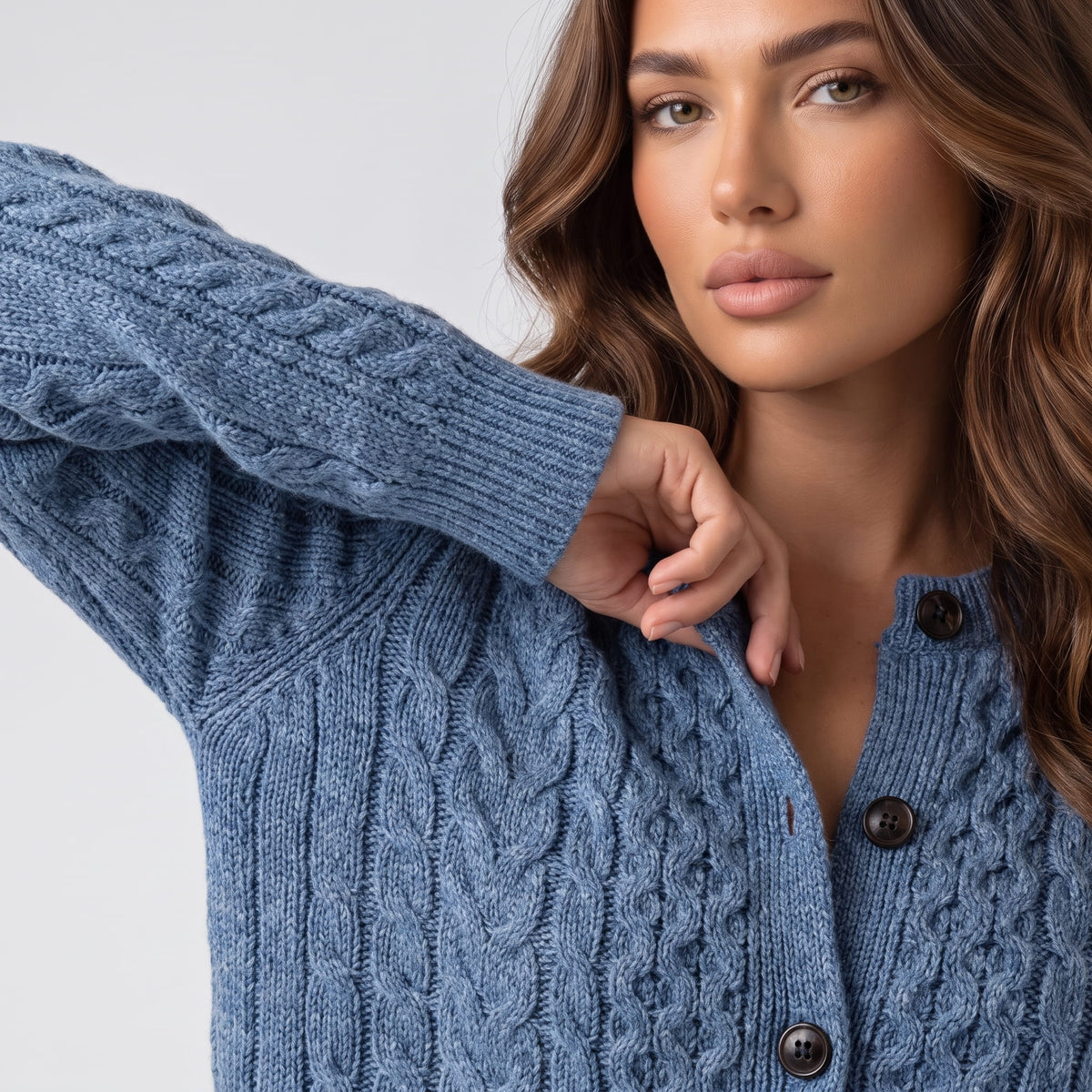Sky blue cable-knit cardigan buttons and cable pattern shown in close view