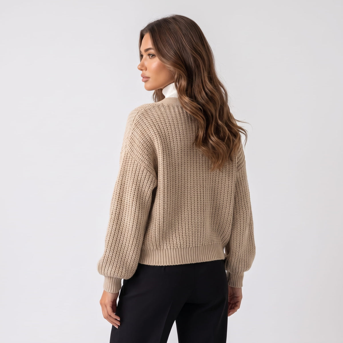 Back view of beige chunky knit cardigan with balloon sleeves