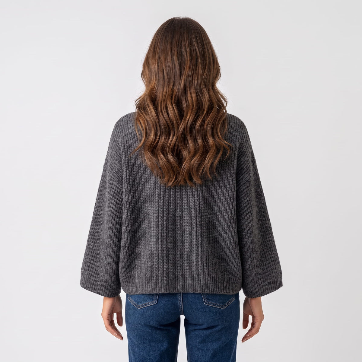 Back view of dark gray cropped sweater with wide sleeves