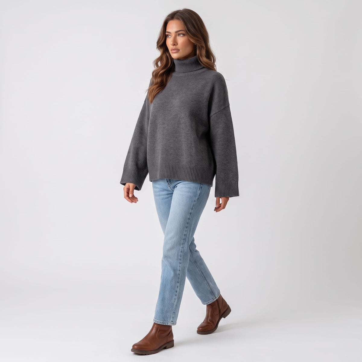 Model walking in the dark gray sweater and jeans, showing the boxy cropped shape