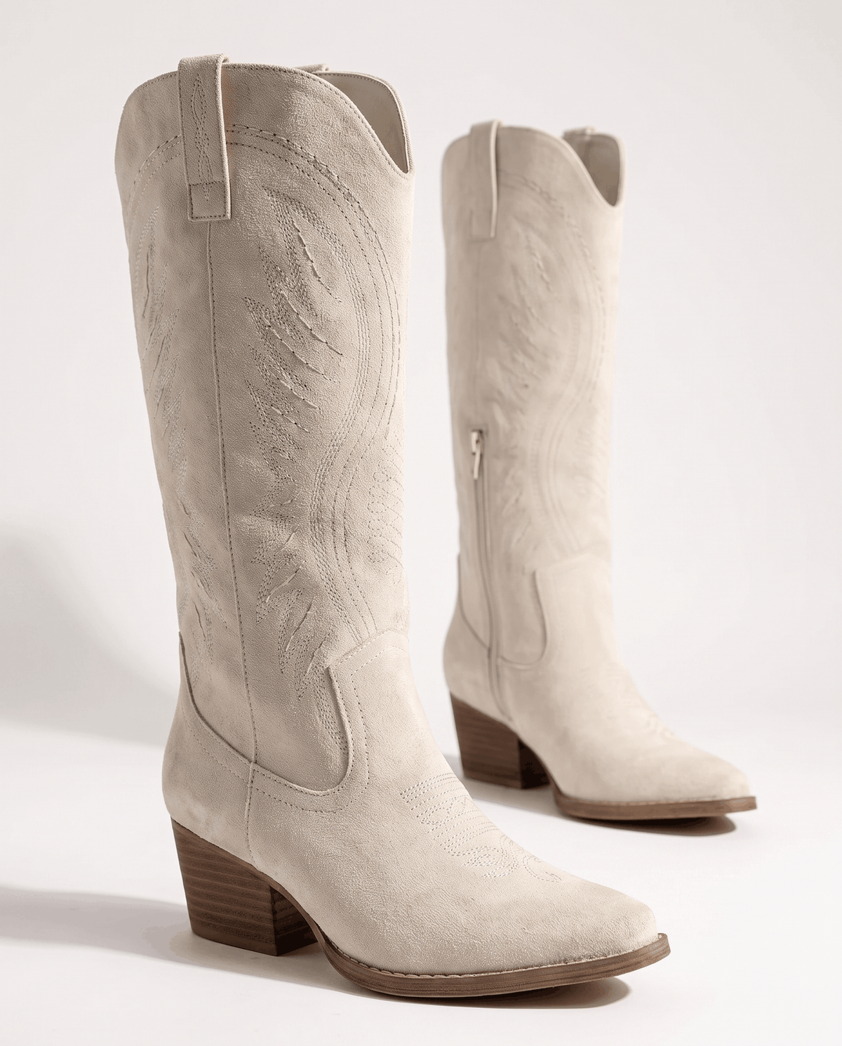 Cream pair angled to show tonal embroidery and the inside zip