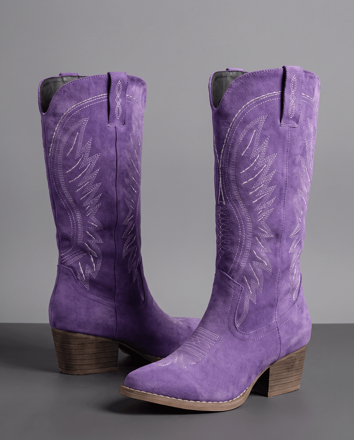 Purple pair on a dark floor showing tonal embroidery and stacked heel