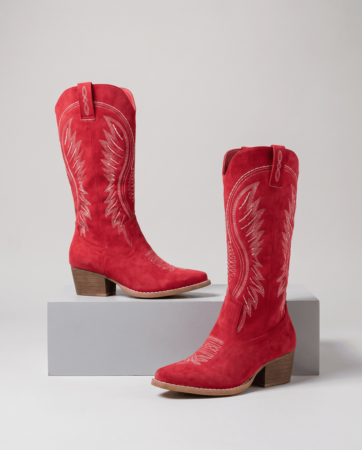Red pair on a gray step showing the side profile and block heel