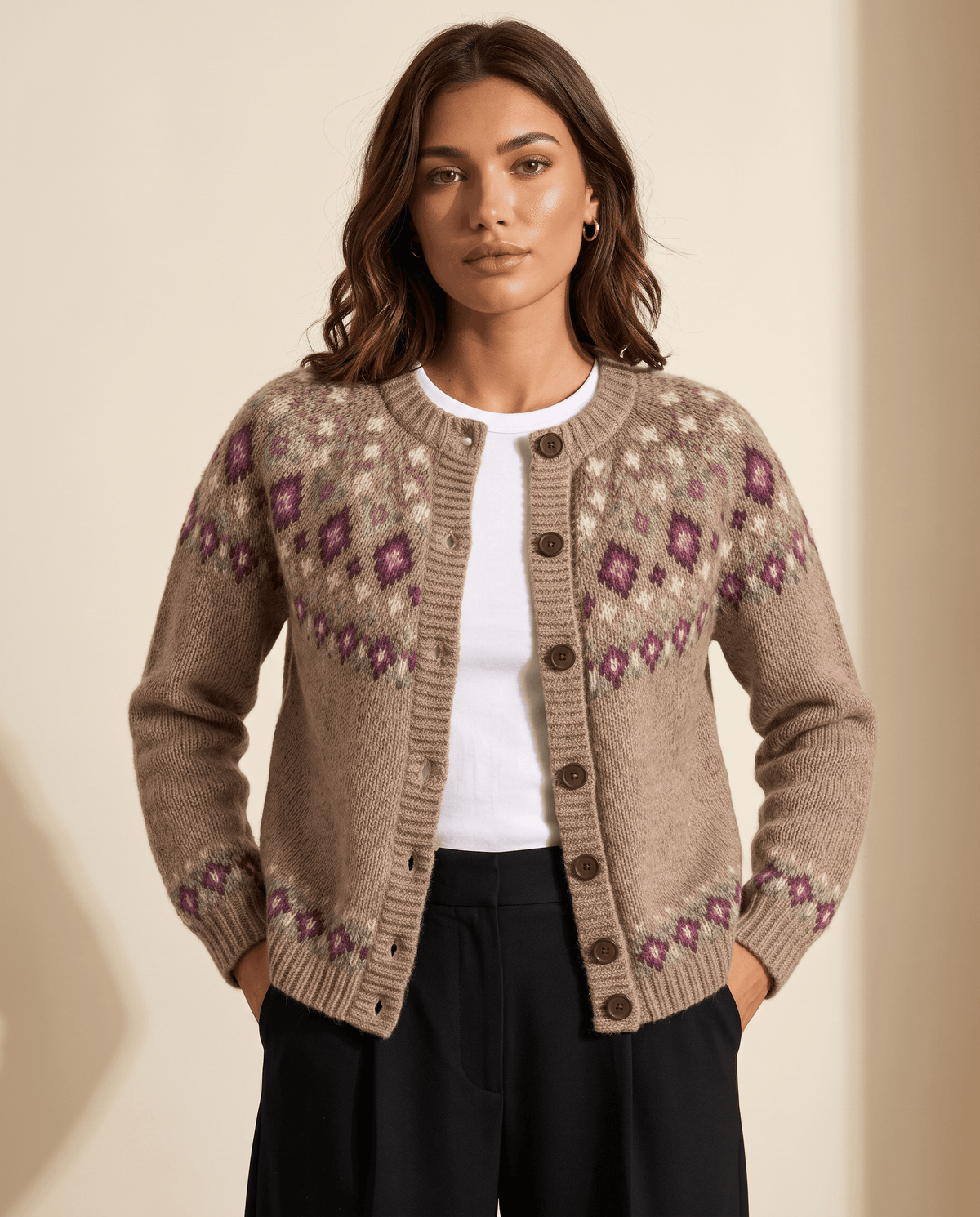 Woman wearing a camel Fair Isle yoke cardigan buttoned over a white tee