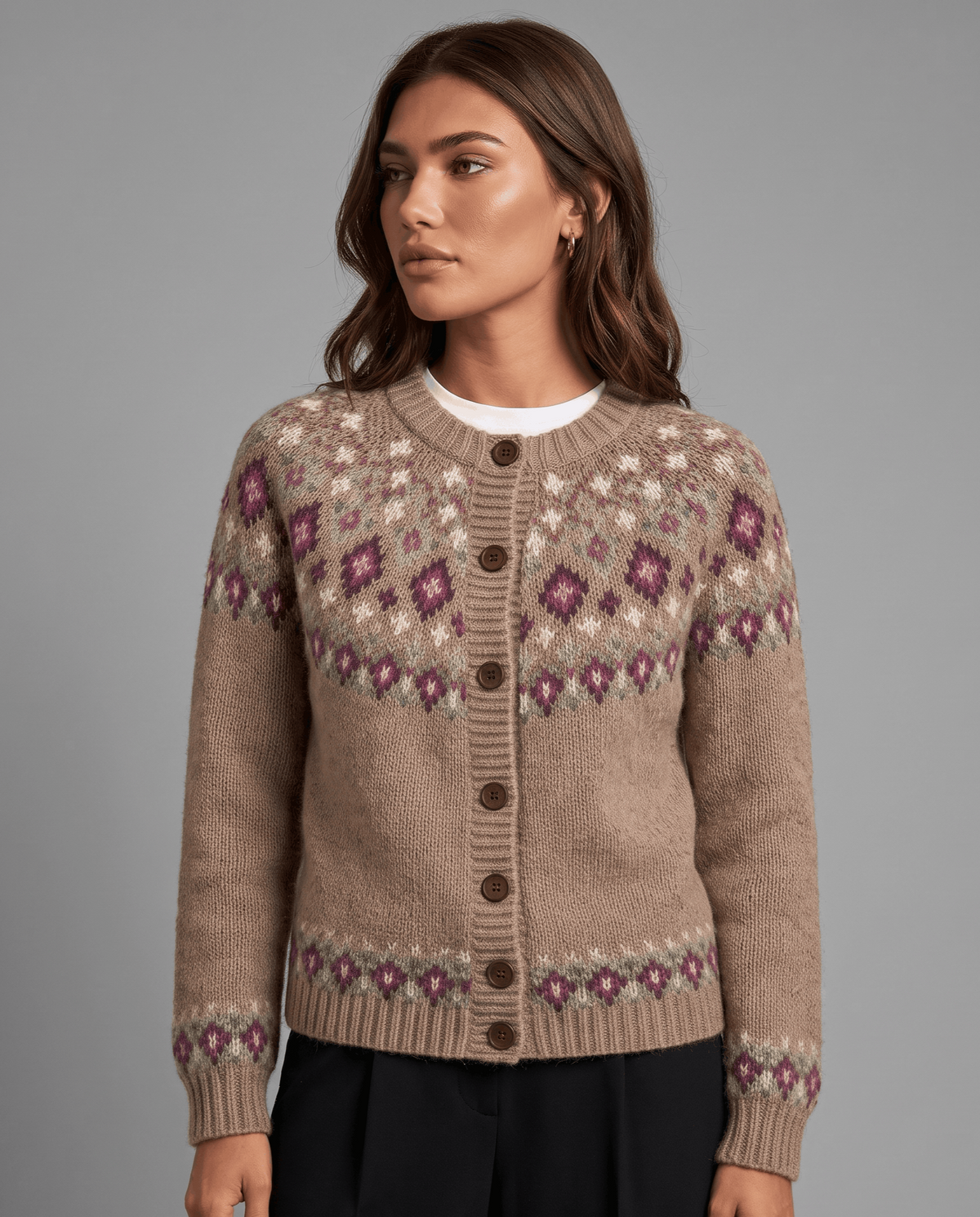 Three-quarter view of a camel Fair Isle yoke cardigan with a patterned hem