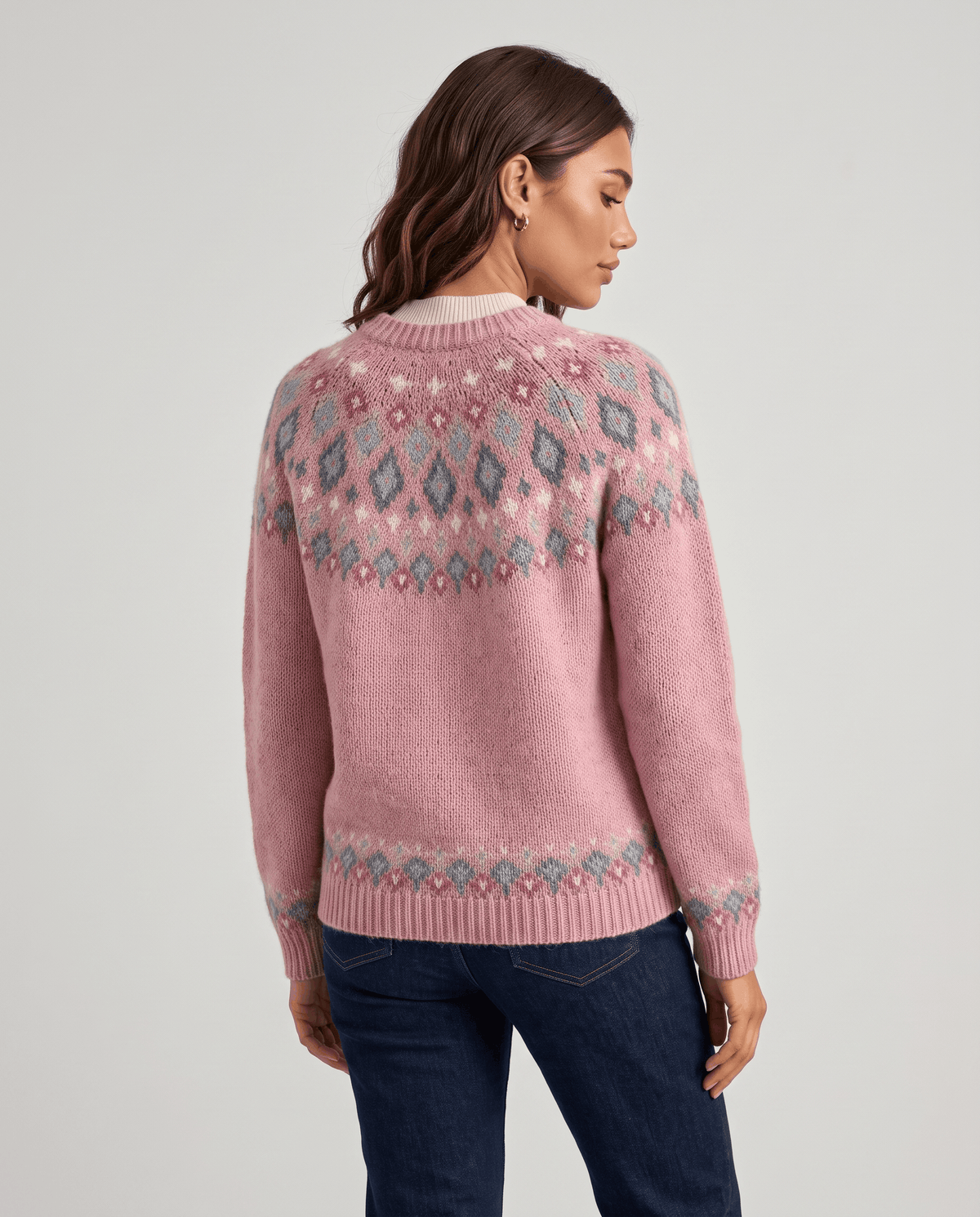Back view of a pink Fair Isle cardigan showing the patterned yoke and hem