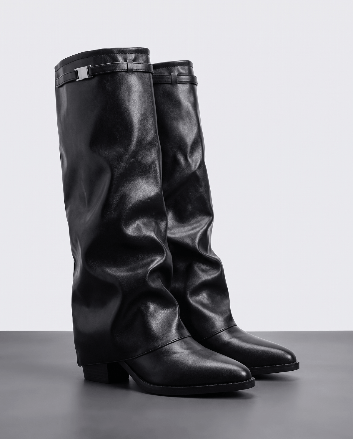 Black pair on a gray floor showing the gathered shaft and low heel