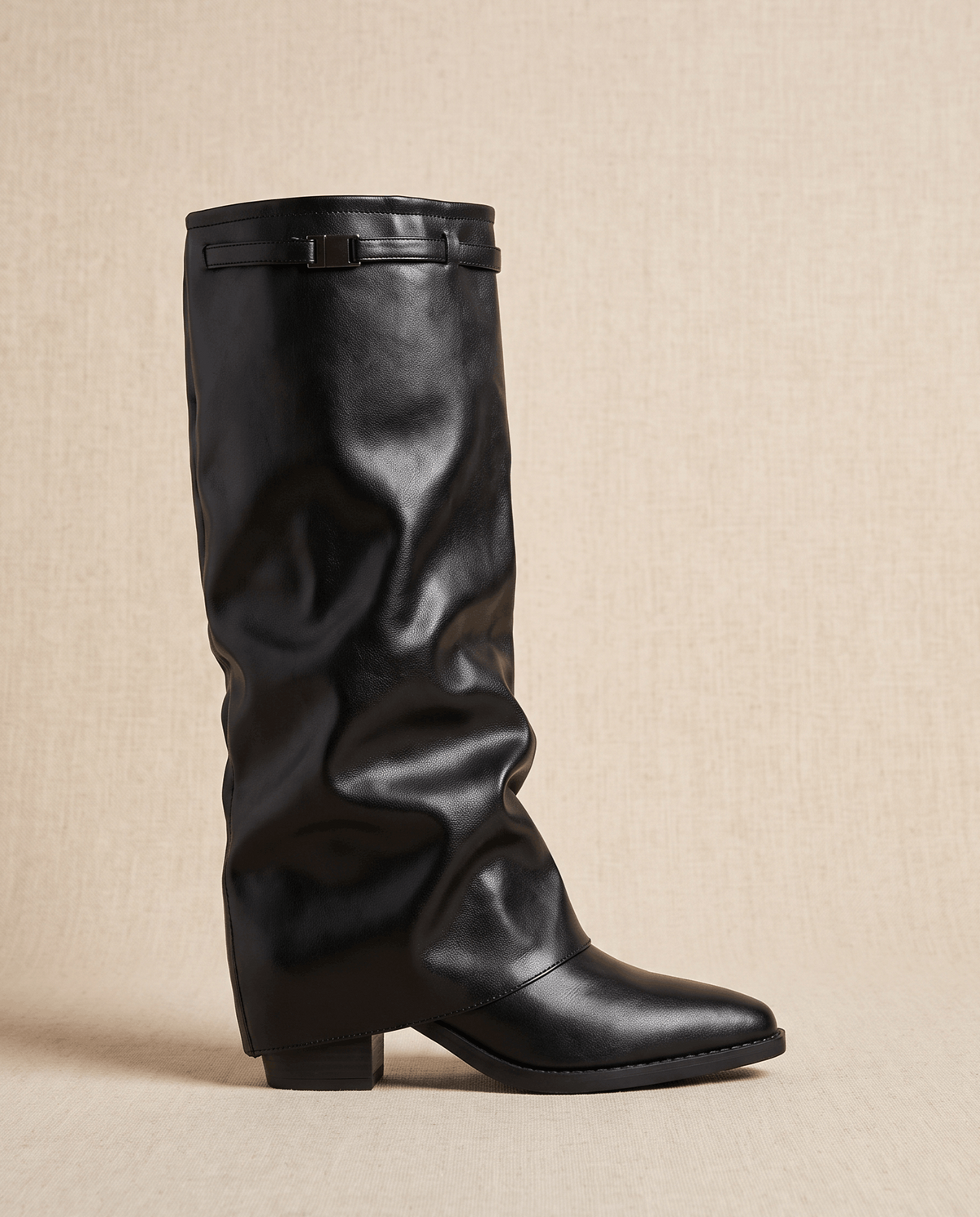 Single black boot in side profile showing the fold-over shaft and pointed toe