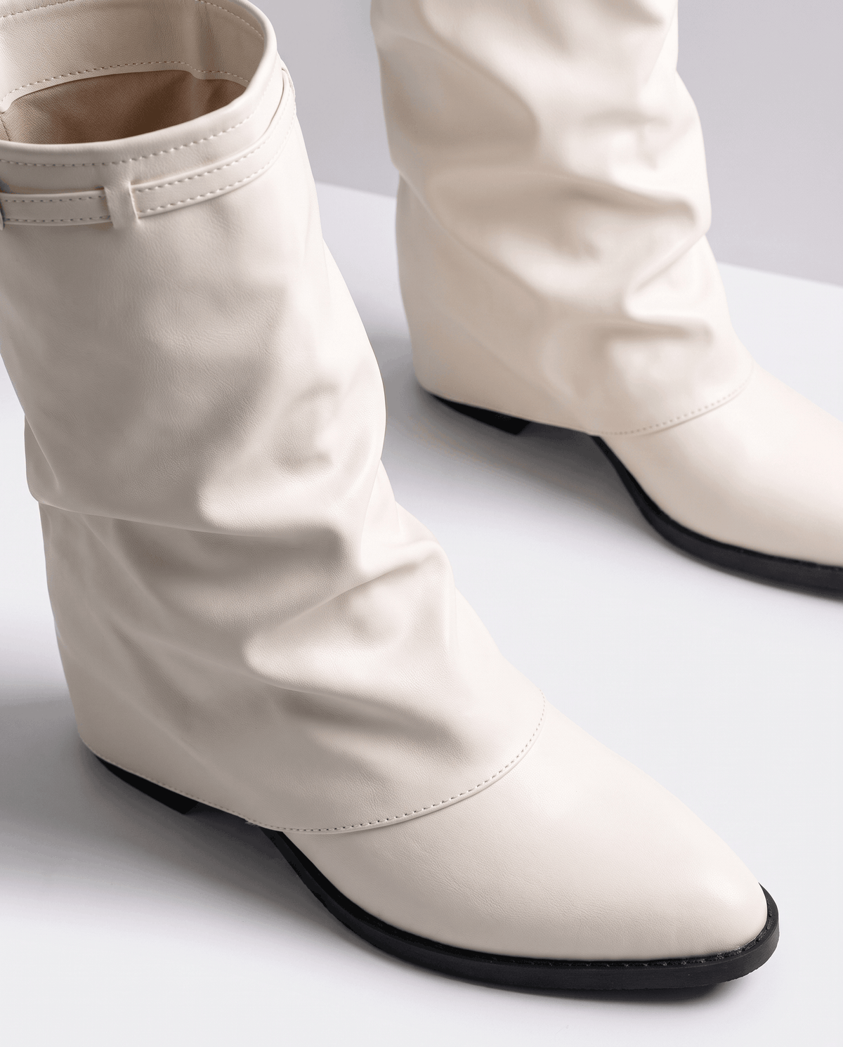 Close-up of the cream cuff strap and gathered shaft from above
