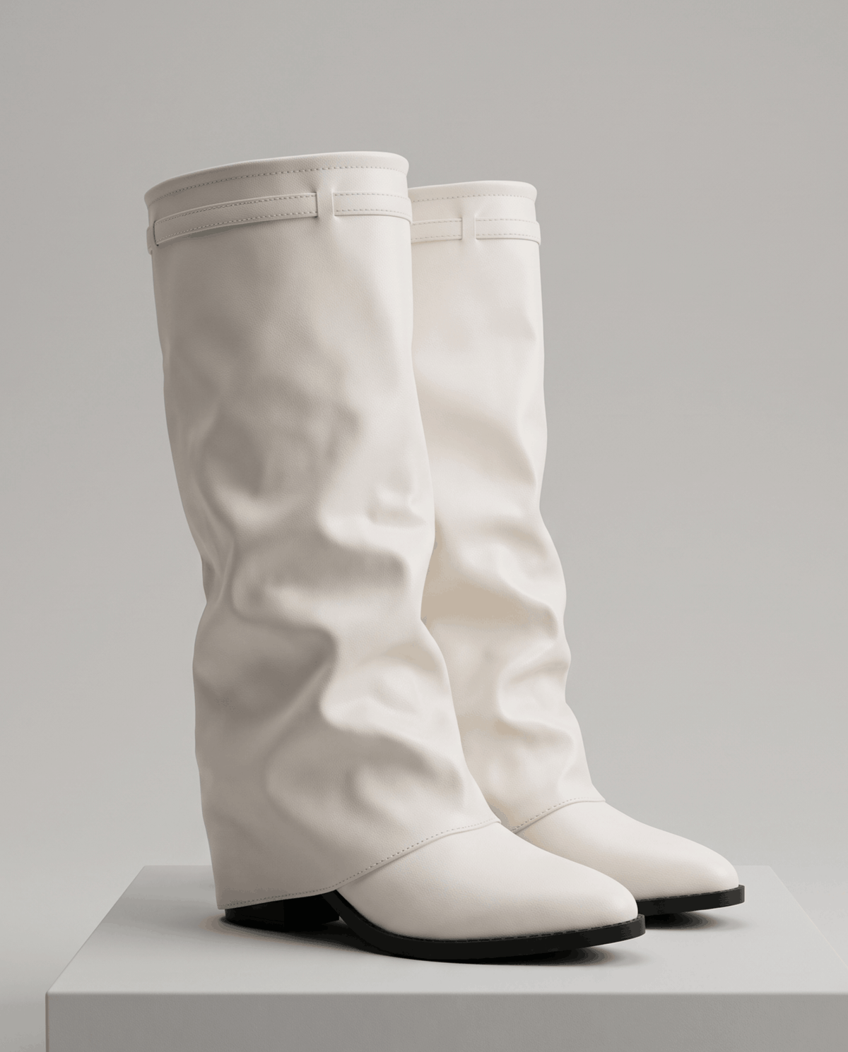 Knee-high fold-over slouch boots in cream leather-look finish on a white display block